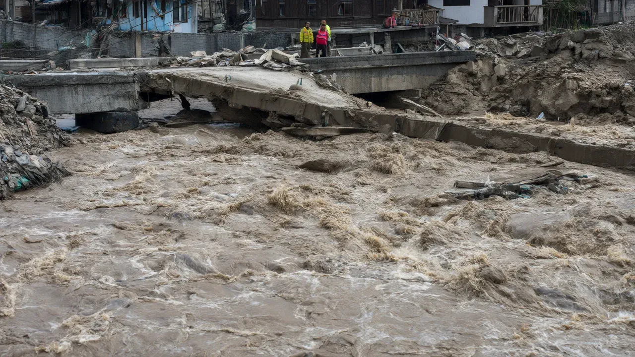 A collapsed bridge in Nepal's Gorkha district illustrates the infrastructure damage from a sudden flash flood that swept away dozens of homes and severed critical connectivity.