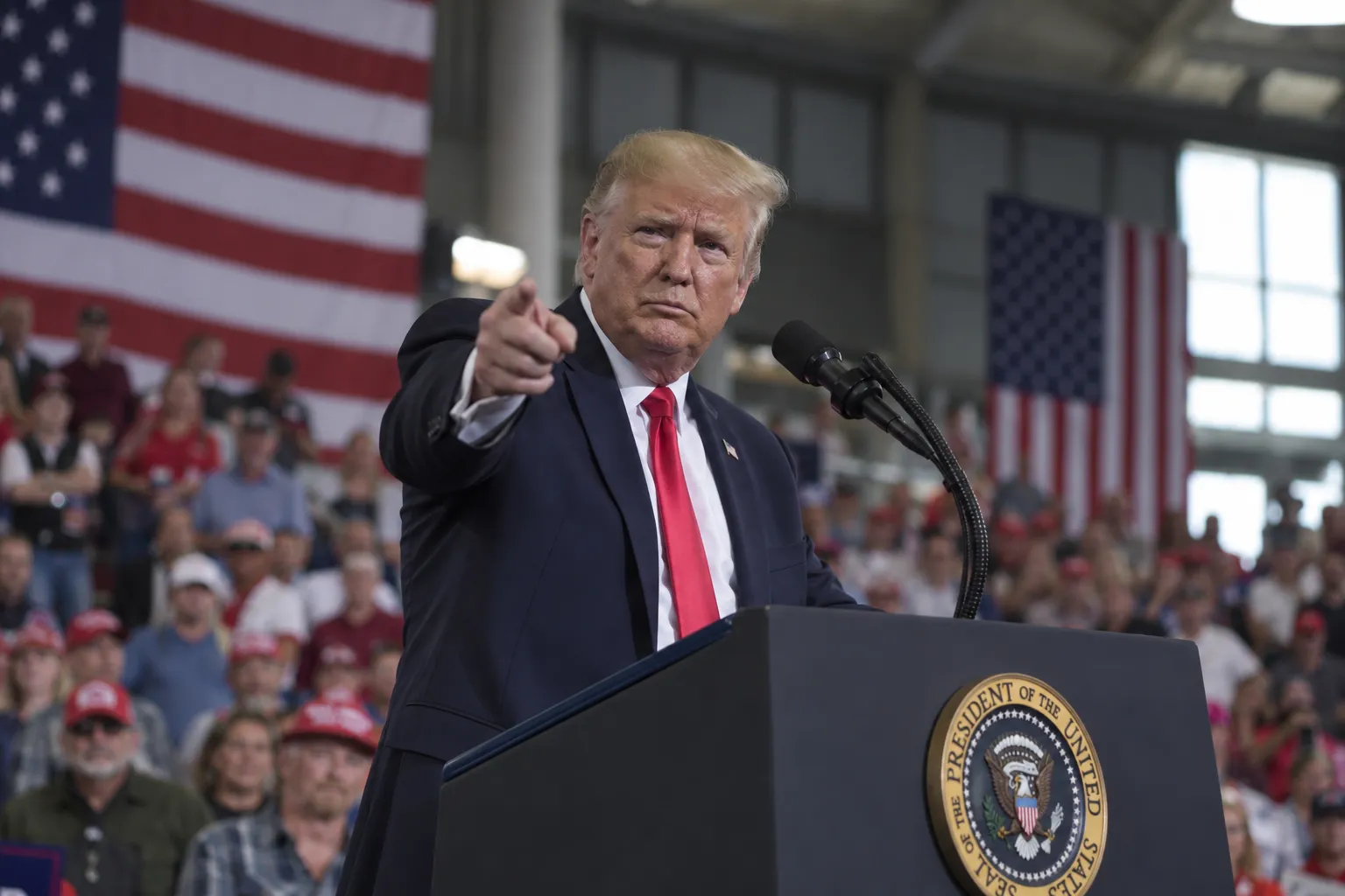 President Trump gestures to a crowd in Grand Island, Nebraska, during a rally where he linked the war with Iran to potential threats against California cities.